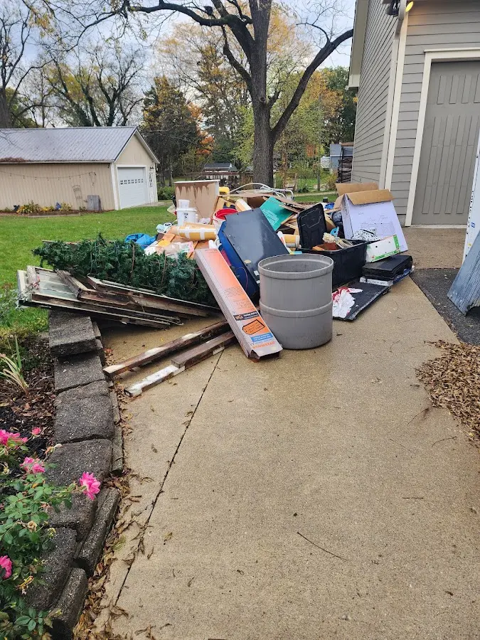Dumpster being loaded with debris for Estate Cleanout Dumpster Rental in Pampa